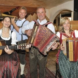Volksmusikgruppe spielt in Almhütte